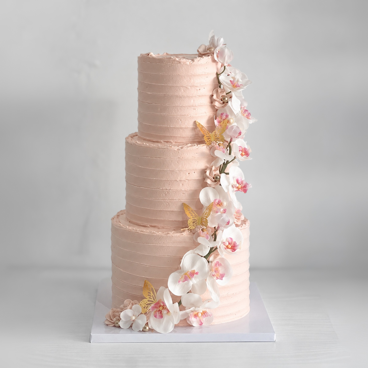 Owner wedding cake reference with a diagonal floral cascade