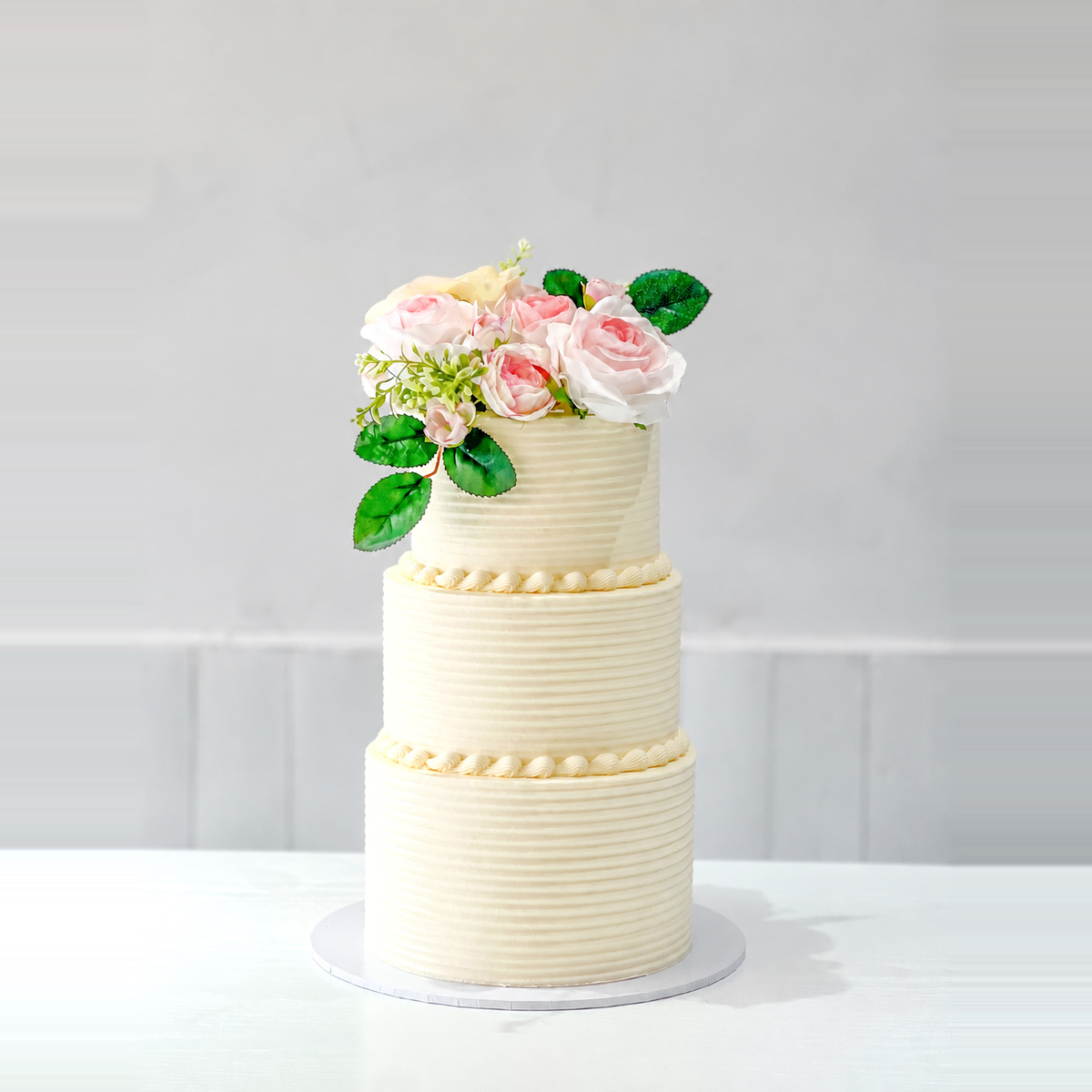 Owner cake reference with flowers arranged on top